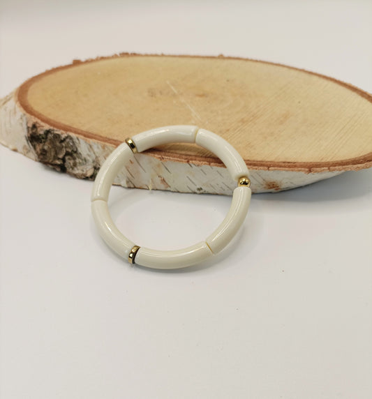 Bracelet élastiqué tubes fins blanc cassé, rondelles en hématite et perle dorée en acier inoxydable  